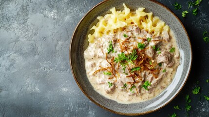 Creamy Meat Dish with Pasta and Fresh Herbs on Rustic Table