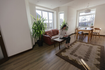 Woman working using laptop from home 