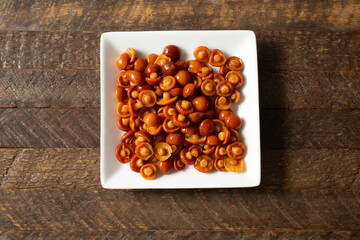 A top down view of a pile of canned nameko mushrooms.