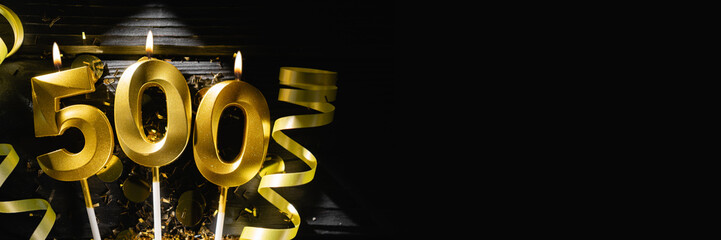 Golden candle number 500 as number of followers or likes in social media. Festive black background....