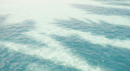 Obraz premium Tranquil clear blue ocean water ripples with sunlight reflections