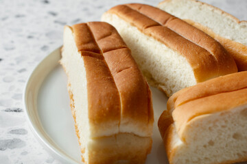 A closeup view of a plate of New England split top buns.