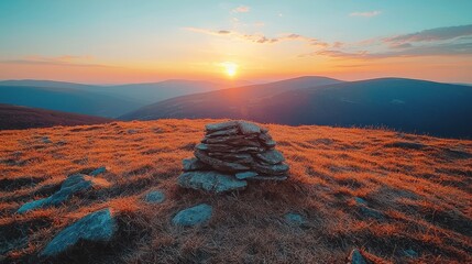 Mountaintop sunset, stone cairn