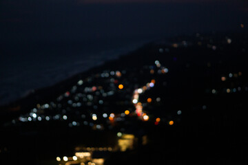 Blurry Aerial view of nightlife beach side with traffic light and sunset sky © Tito Rollis