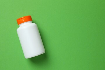 White bottle on color  background, top view