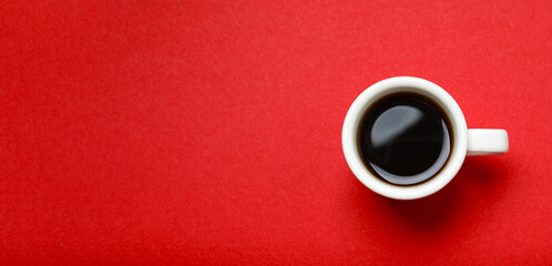 Cup of coffee on red background