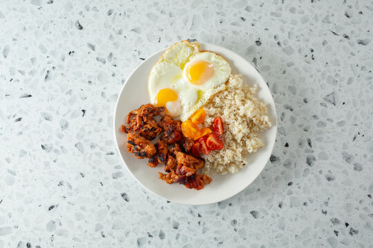 A top down view of a chicken tocino breakfast plate.