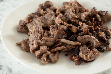 A closeup view of a plate of beef tapa.
