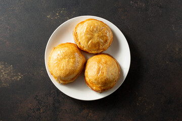 A top down view of a plate of meat pies.