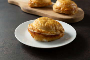 A view of a meat pie, on a plate.