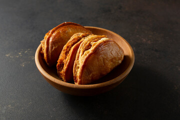 A view of some empanadas, in a bowl.