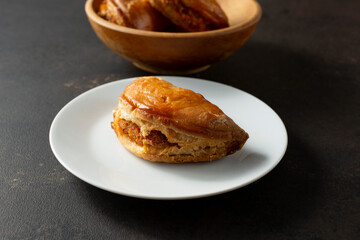 A view of an empanada, on a plate.