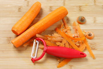Peeling carrots with a peeler. Kitchen work.