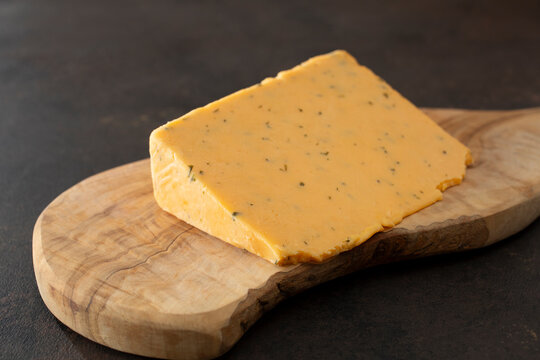 A view of a block of double gloucester cheese.