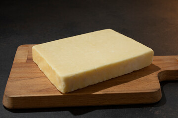 A view of a block of English coastal cheddar cheese.