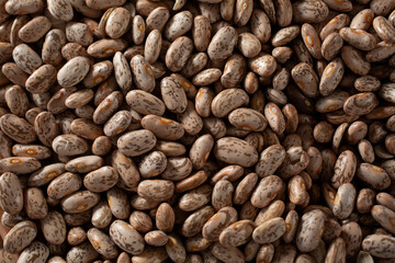A top down view of a pile of dry pinto beans, as a background.