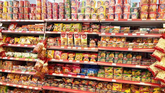 Jakarta, February 21, 2025: Grocery store shelves with instant noodles in a market in Jakarta, Indonesia. Variety brand of instant foods product on shelf rack display in a grocery store supermarket