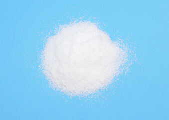 Thiourea powder on blue background.