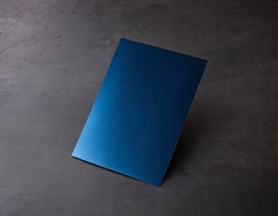 Elegant dark blue folder positioned on a textured gray surface.
