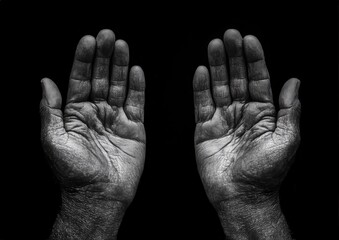 Fototapeta premium A hands reach out to each other on a black background
