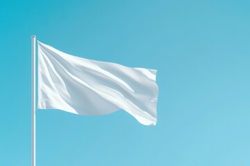 isolated blank white flag gently waving on flagpole against clear blue sky with ample copy space all around for potential