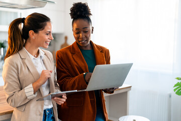 Two Professional Women Collaborating Intently in a Bright Modern Home Office Setting