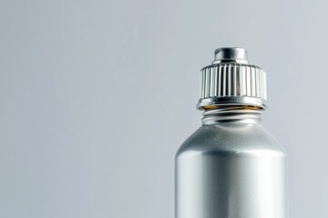 A silver metal bottle with a metal cap, suitable for use in product photography or as a decorative item