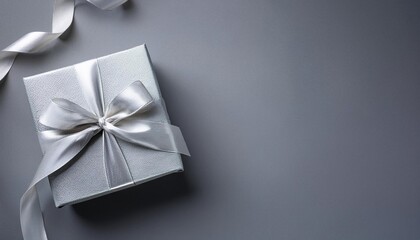 Gray Gift Box with Silver Ribbon on Gray Background. Top View of Teacher Day Gifts with Copy Space