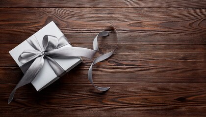 Gray Gift Box with Silver Ribbon on Wooden Background. Top View of Teacher Day Gifts with Copy Space