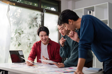 Creative Collaboration in UIUX. Diverse team members engaging in design discussions over project materials.