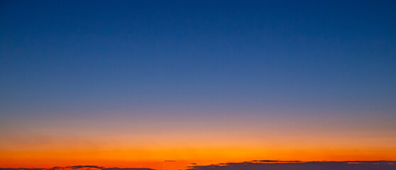 Fototapeta premium Sunset dark blue sky with orange gradient. Sky landscape, panorama