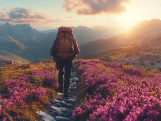 Fotobehang A Lone Hiker's Journey: Majestic Mountain Vistas and Vibrant Floral Paths at Sunset, Exploring Nature's Beauty and Finding Peace in the Wilderness © Asad