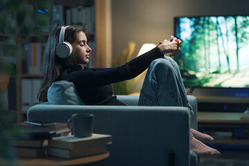 Relaxed teenager listening to music at home