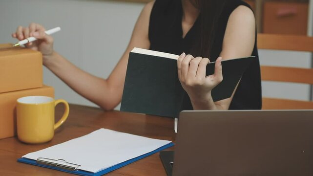businesswoman start small business and successful SME entrepreneurs asian woman hoding boxs works from home delivering parcels online. SME delivery concept and packaging