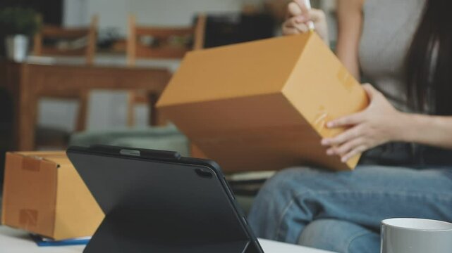businesswoman start small business and successful SME entrepreneurs asian woman hoding boxs works from home delivering parcels online. SME delivery concept and packaging