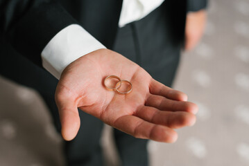 Close Up Of Groom Handling Wedding Rings