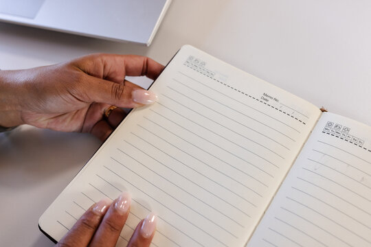 Close-up of hands holding open notebook, ready for writing notes at office, copy space
