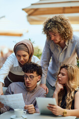 A Diverse MultiEthnic Group Reviewing Projects During a Work Break in a Caffee.