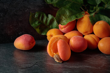 Apricots on a black stone table.