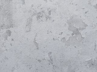 White Concrete Wall Texture. Rough Painted Textured Surface. White and Light Gray Concrete Backgroud. Close up. Wall with Visible Irregular Brush Marks, Stains and Cracks.