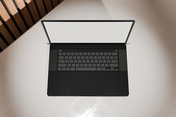 High end laptop on tile studio floor and acoustic backdrop. Blank mockup template screen. Spotlight from above