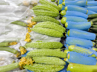 choosing cucumbers at the grocery store