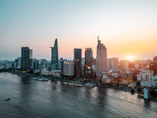 beautiful sunset over Ho Chi Minh city skyline and Saigon river, green tropical park and financial...