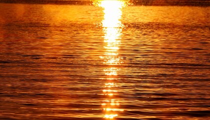 orange and yellow gentle waves reflect warm sunlight producing glistening highlights that evoke a calm and serene atmosphere