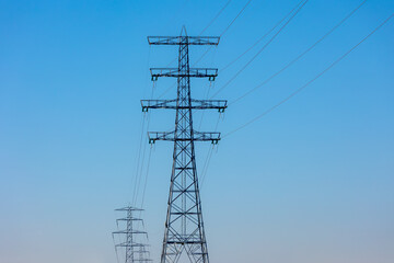 Electric high voltage pole with blue clear sky background, Transmission line pylon lattice tower is a tall structure usually a steel lattice tower, Used to support an overhead power lines, Netherlands