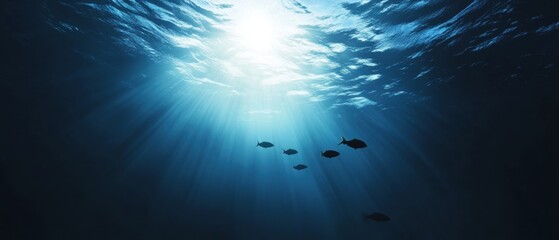 Fototapeta premium Underwater Scene with Sunlight Rays Illuminating Fish Swimming in Deep Blue Ocean Water