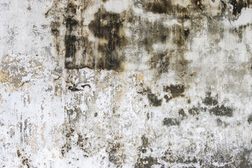 Grungy weathered concrete wall with cracks and stains, exuding a raw, aged texture background