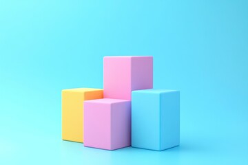 Obraz premium Colorful blocks in pastel shades of yellow, pink, and blue are stacked on a smooth blue surface, creating an inviting and playful arrangement