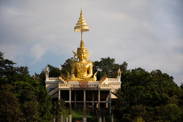 Fototapeta premium Big golden Maitreya or Metteyya buddha image statue of Wat Phra That Doi Saket Temple for thai people and foreign travelers travel visit and respect praying at Chiangmai city in Chiang Mai, Thailand