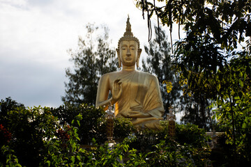 Obraz premium Big golden buddha image statue of Wat Phra That Doi Saket or Phrathat Doi Saket Temple for thai people and foreign travelers travel visit and respect praying at Chiangmai city in Chiang Mai, Thailand